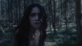 The woman in a forest from the 'The Beast is Coming' teaser.