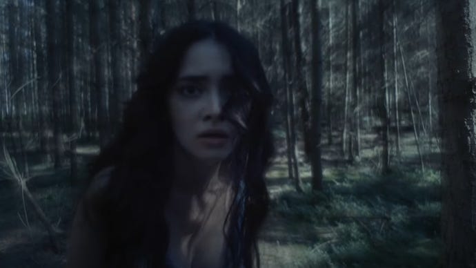 The woman in a forest from the 'The Beast is Coming' teaser.