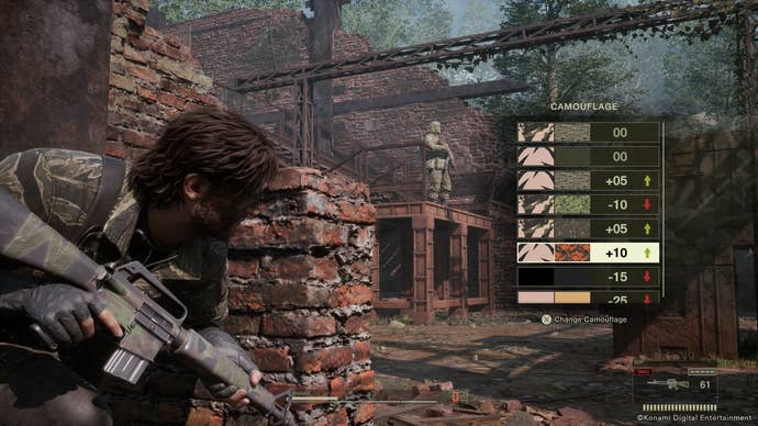 Snake hides behind a wall while looking at his camouflage options in Metal Gear Solid Delta: Snake Eater